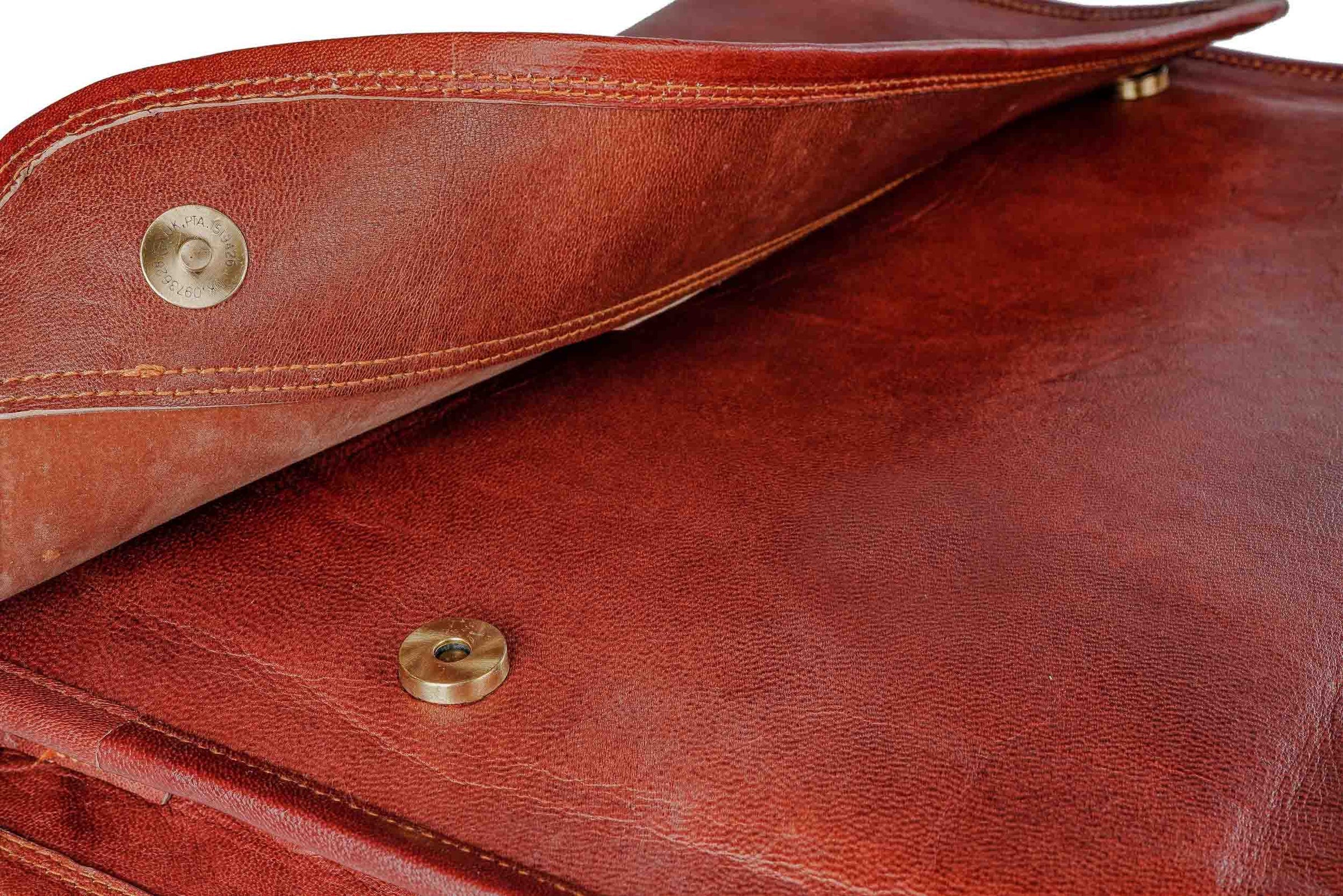 brown leather messenger bag with magnetic buttons